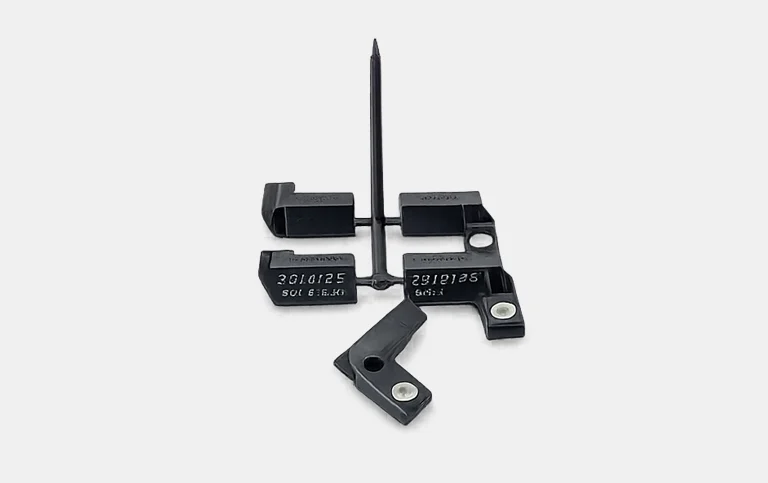 Black clips and brackets with metal bushes on a runner