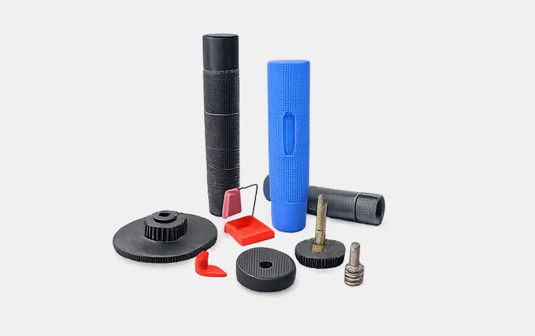 Assorted black and blue grips, knobs and small moulded parts