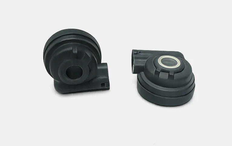 Two black round sensor housings