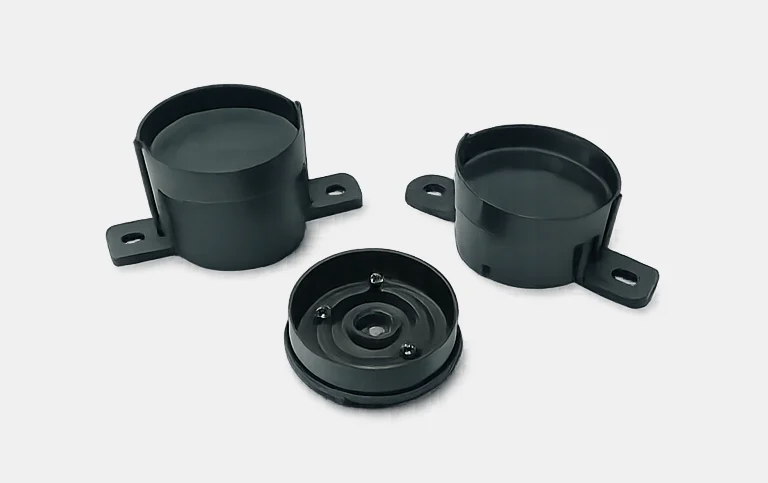 Black round buzzer housings with mounting flanges