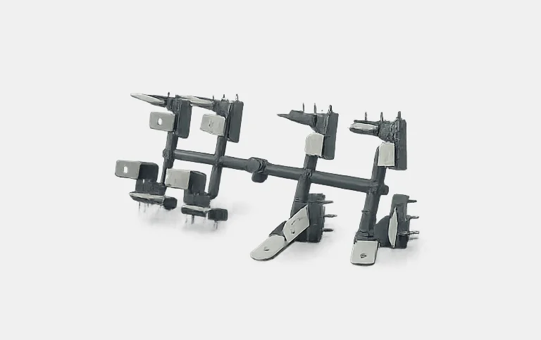 Grey terminal carriers with metal blades on a runner