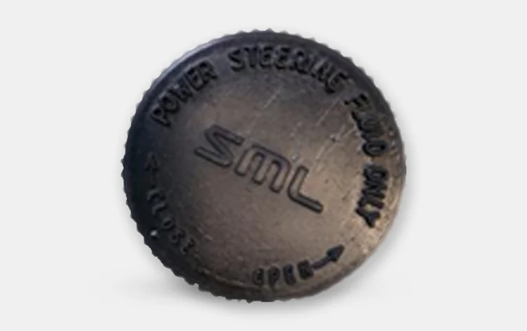 Black power-steering fluid cap with embossed lettering