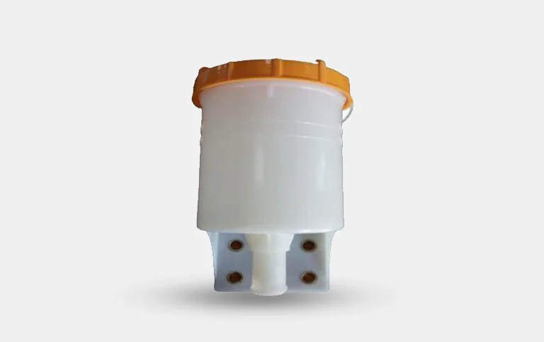 Reservoir body with brass connector inserts at the base